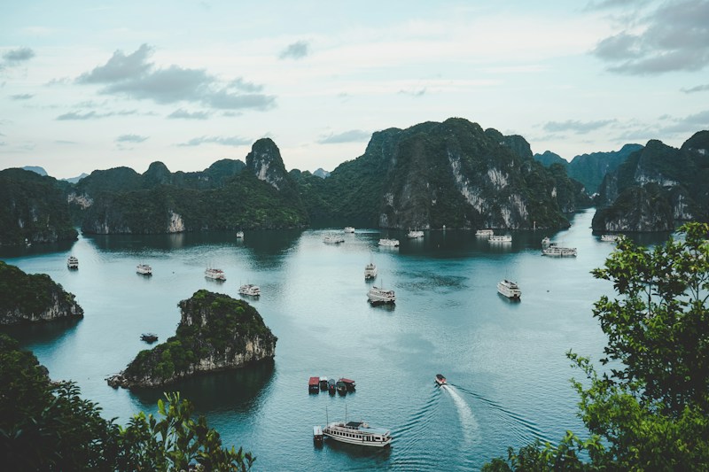 Tropical turquoise bay with karst limestone islands and boat